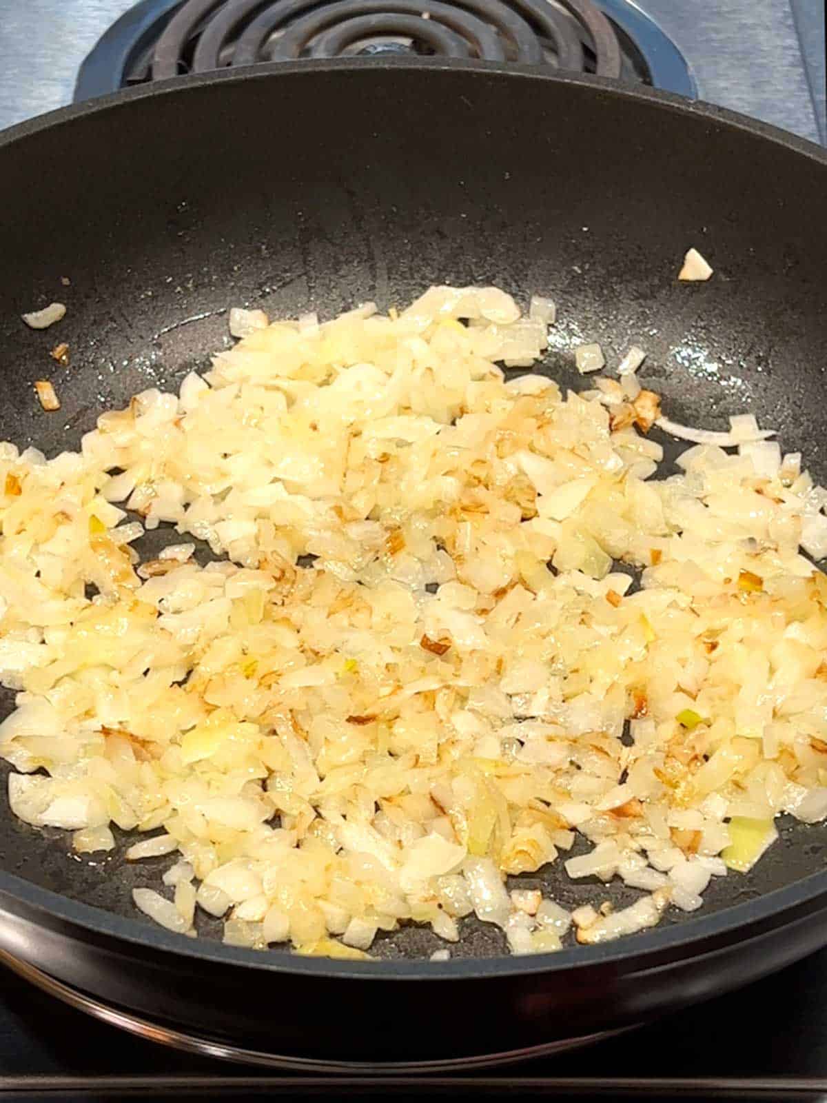 Cooking onions in skillet.