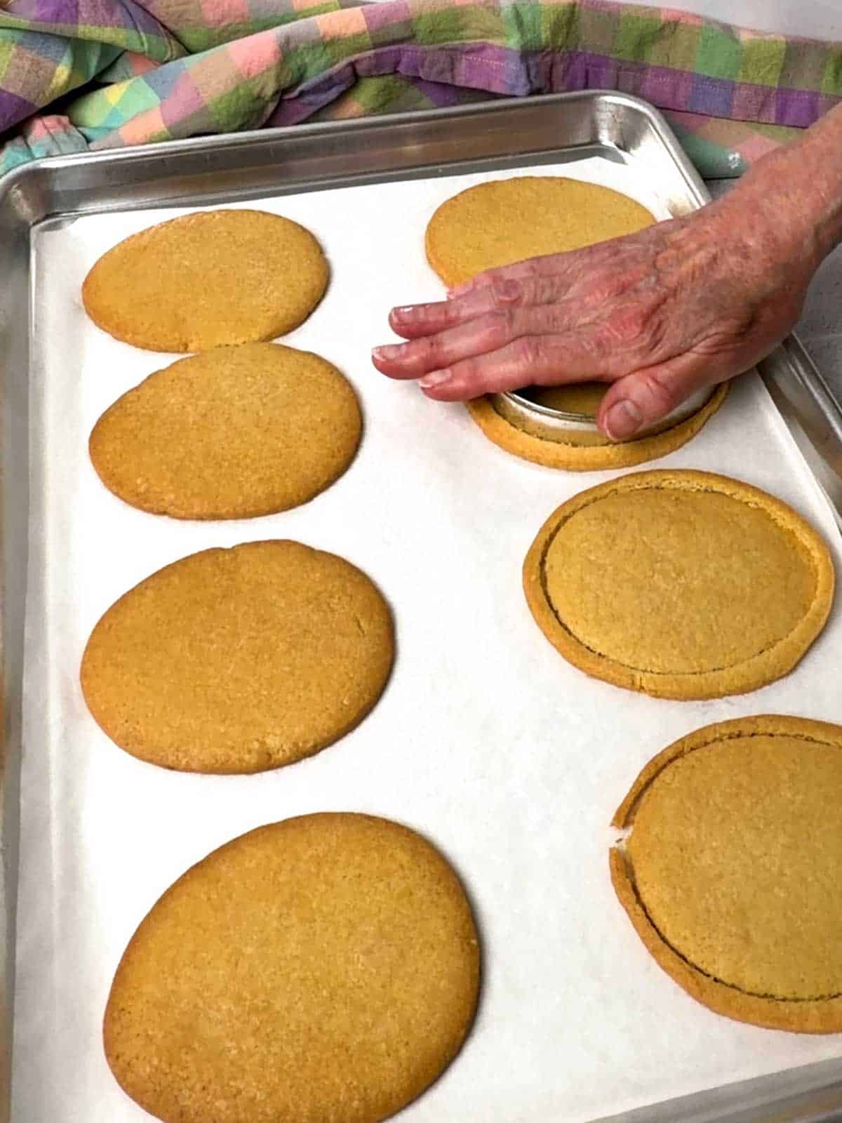 Cutting the baked cookies to shape.