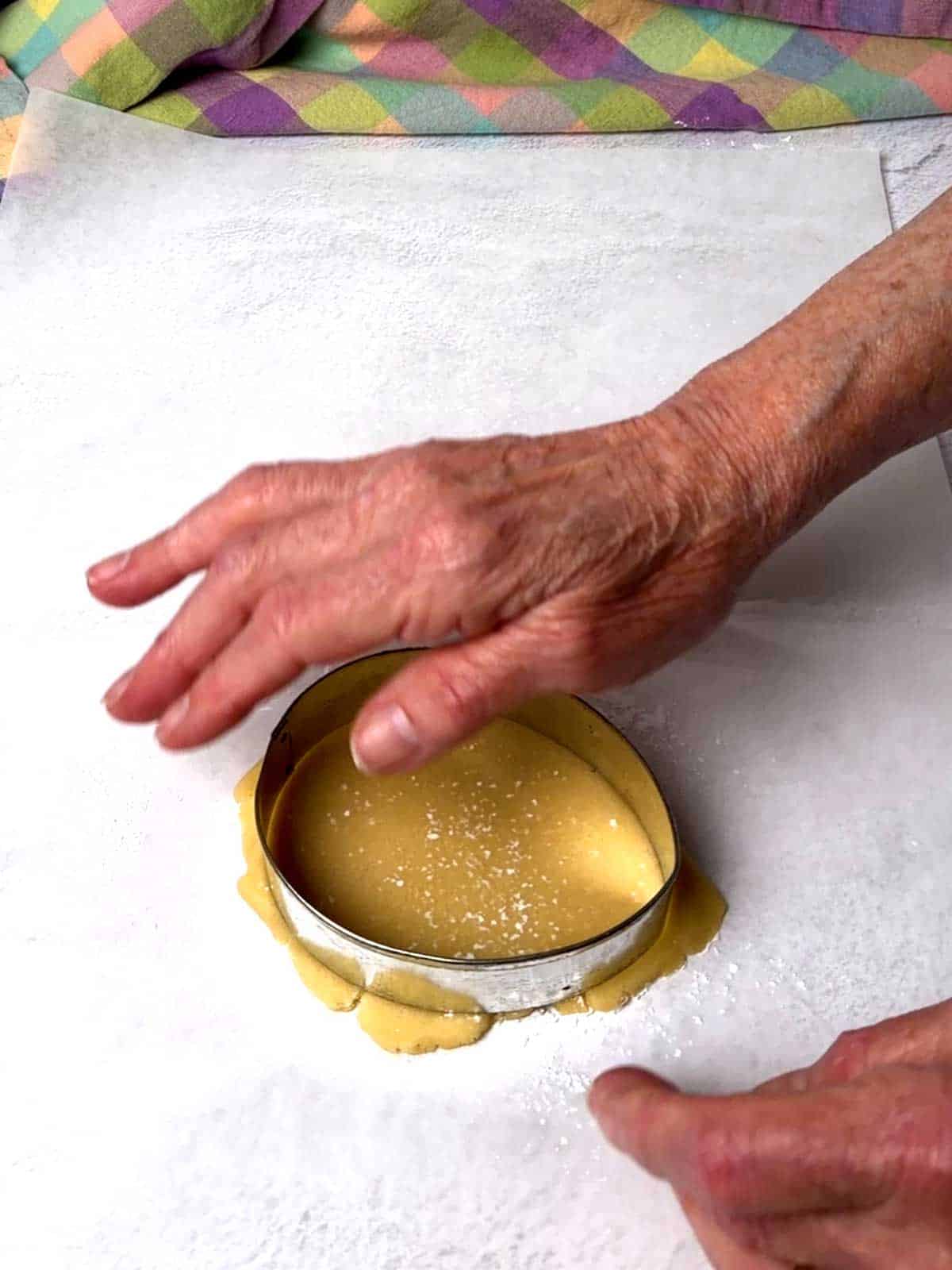 Cutting the dough with an egg-shaped cookie cutter.