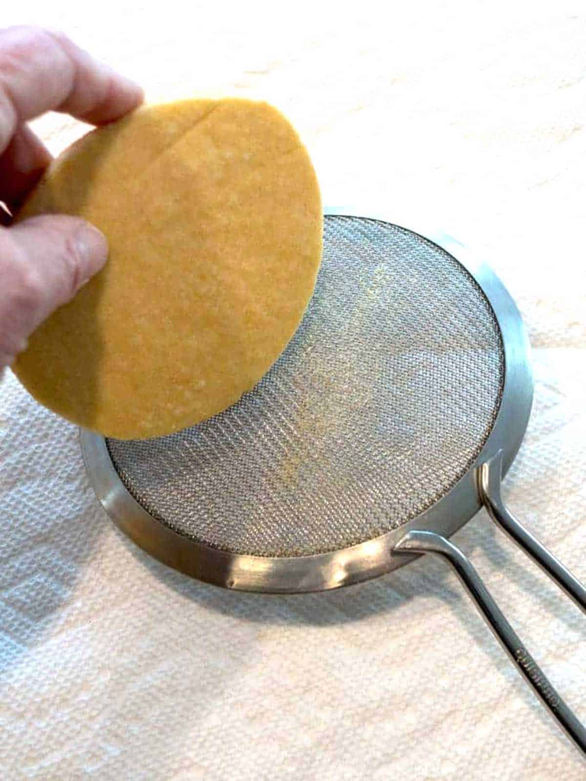 Smoothing the edges of the trimmed cookie.