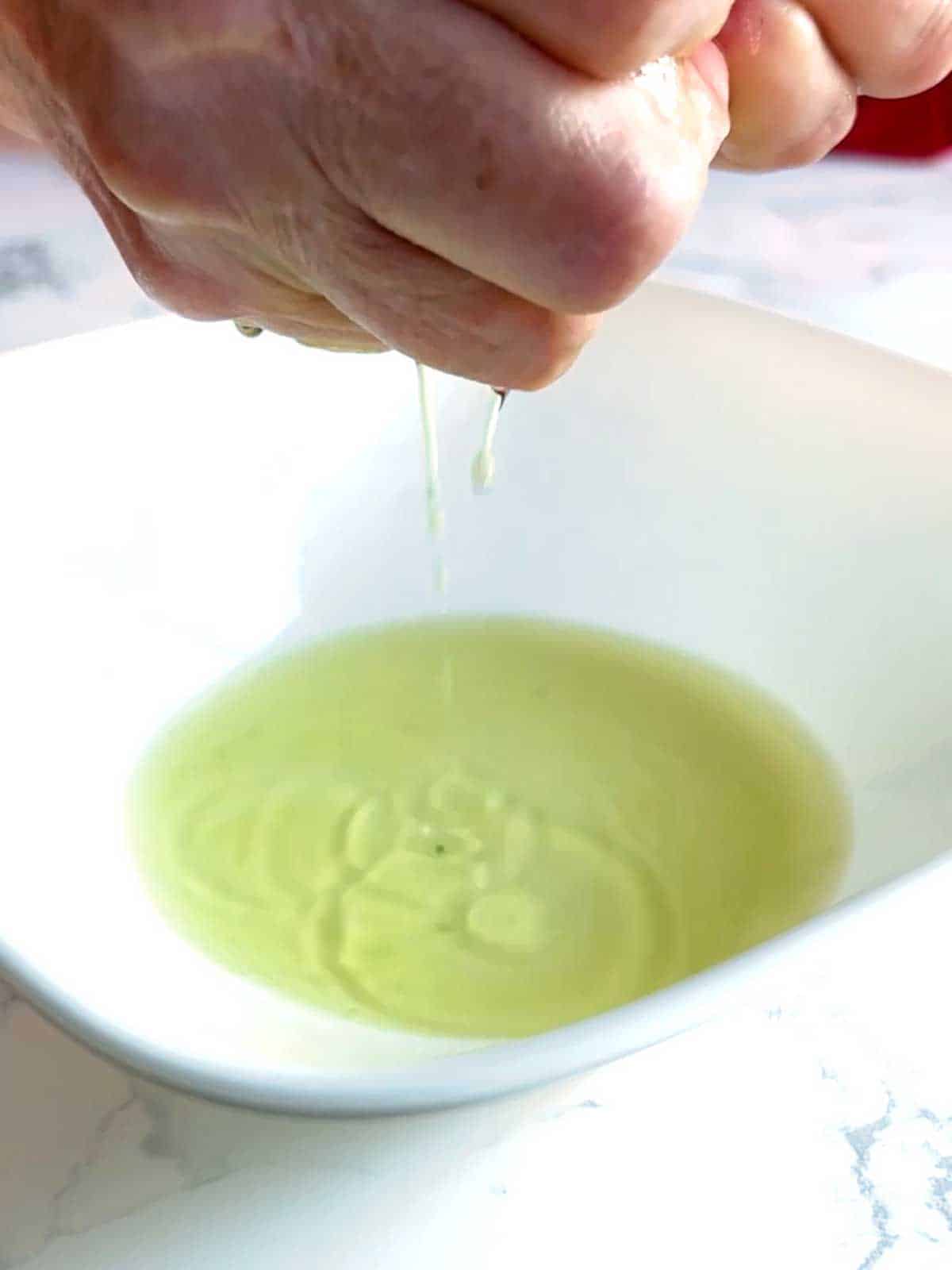 Squeezing liquid from spinach.