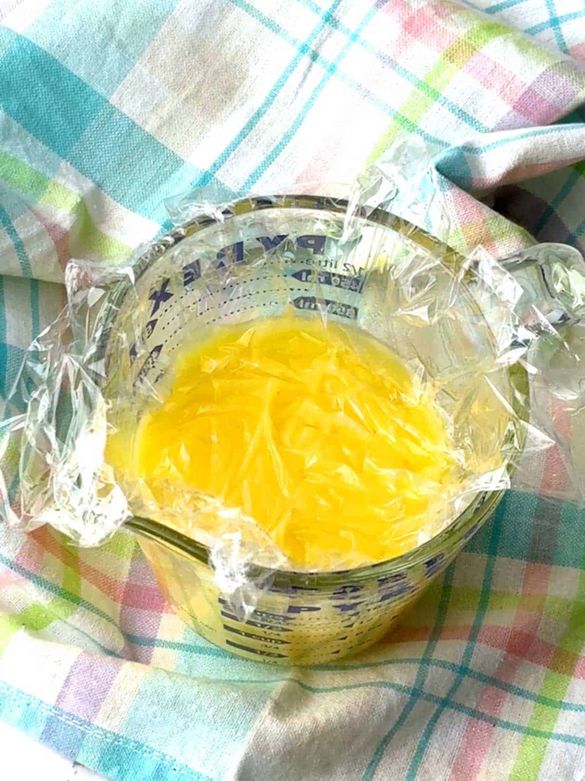 Plastic wrap placed onto the lemon curd.
