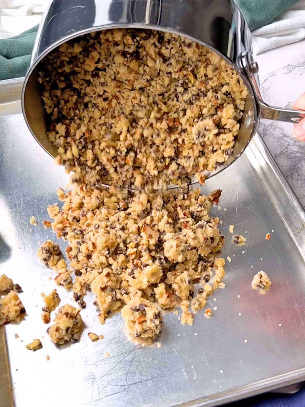 Transferring cookie brittle to a large rimmed baking sheet.