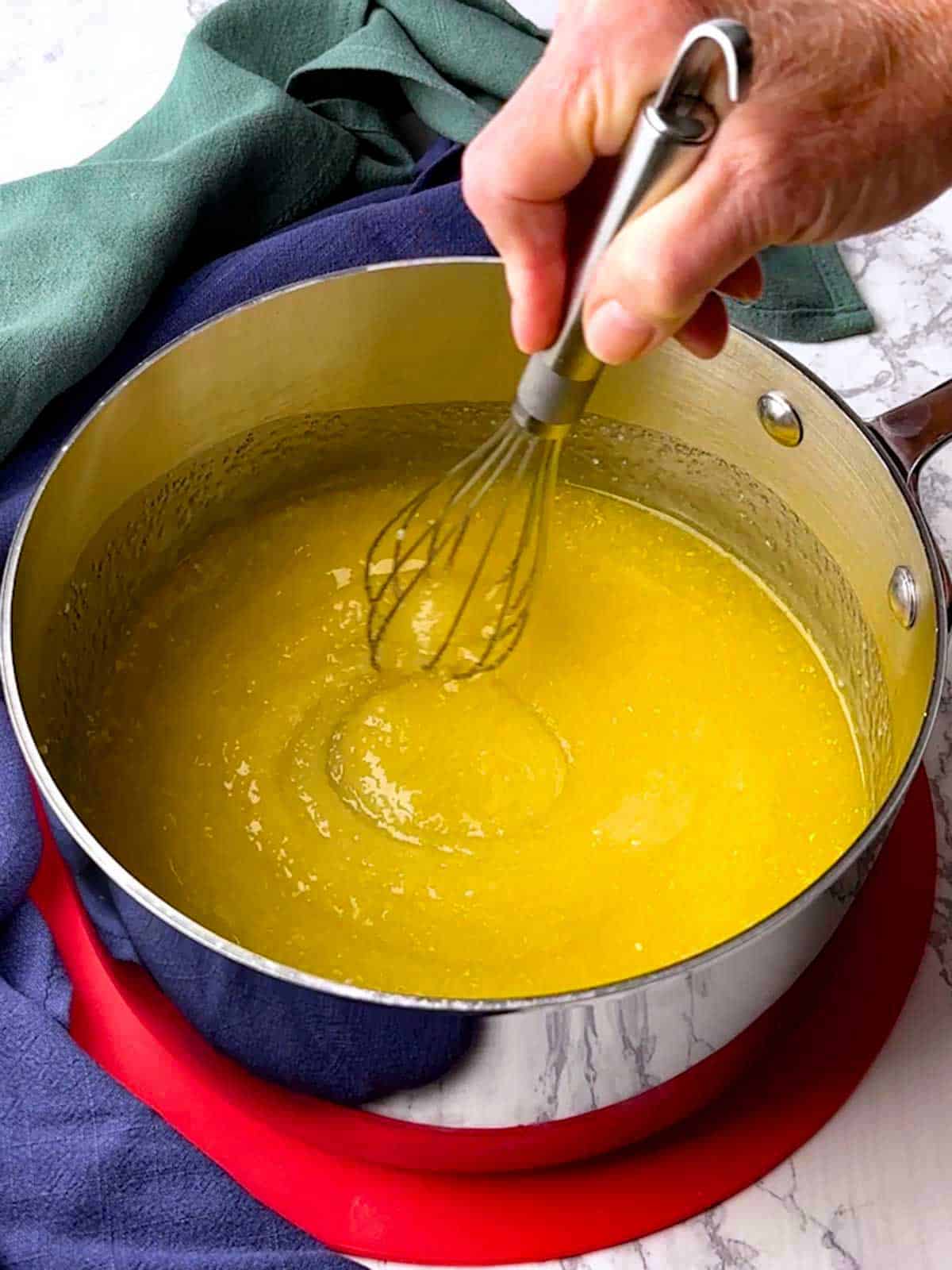 Whisking the butter, sugar and vanilla extract together.