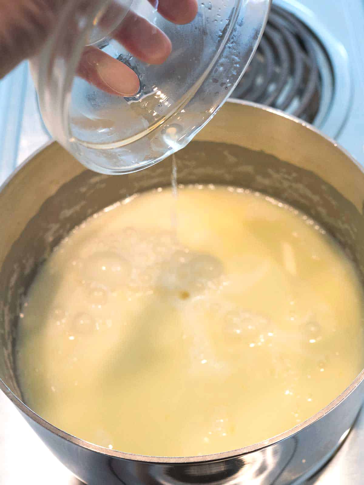 Adding lemon juice to the mixture.