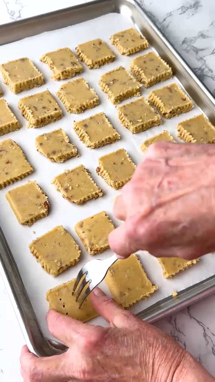 Piercing or docking the cookies with a fork.