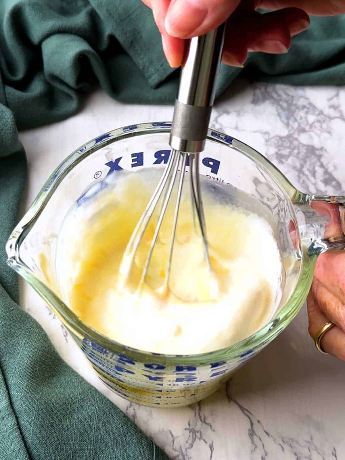 Whisking together eggs and heavy cream for the custard for the Quiche Lorraine.