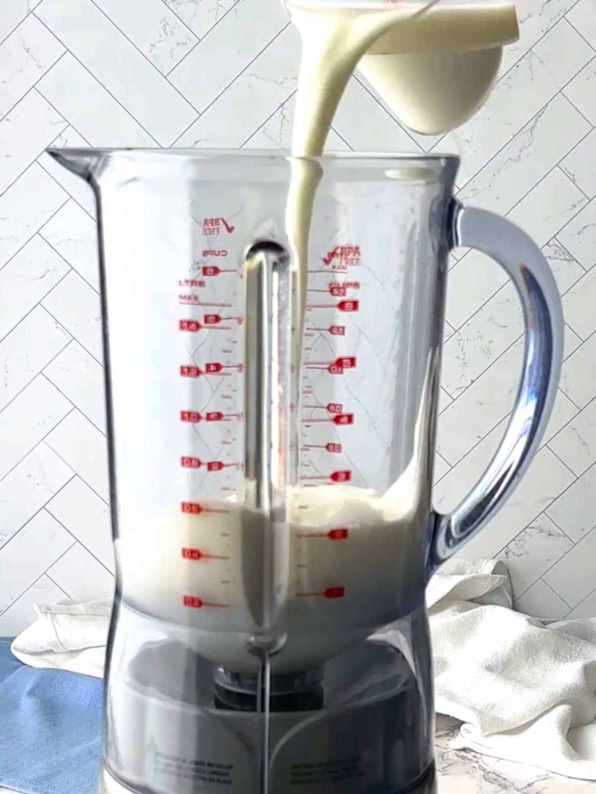 Adding milk to the blender.