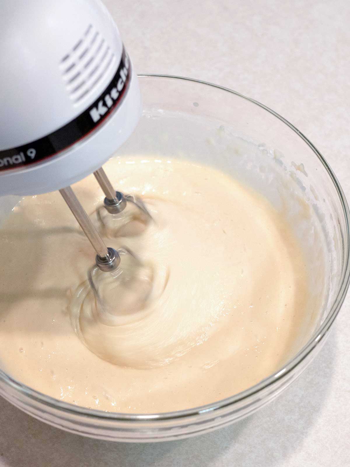 Beating the batter with electric mixer.