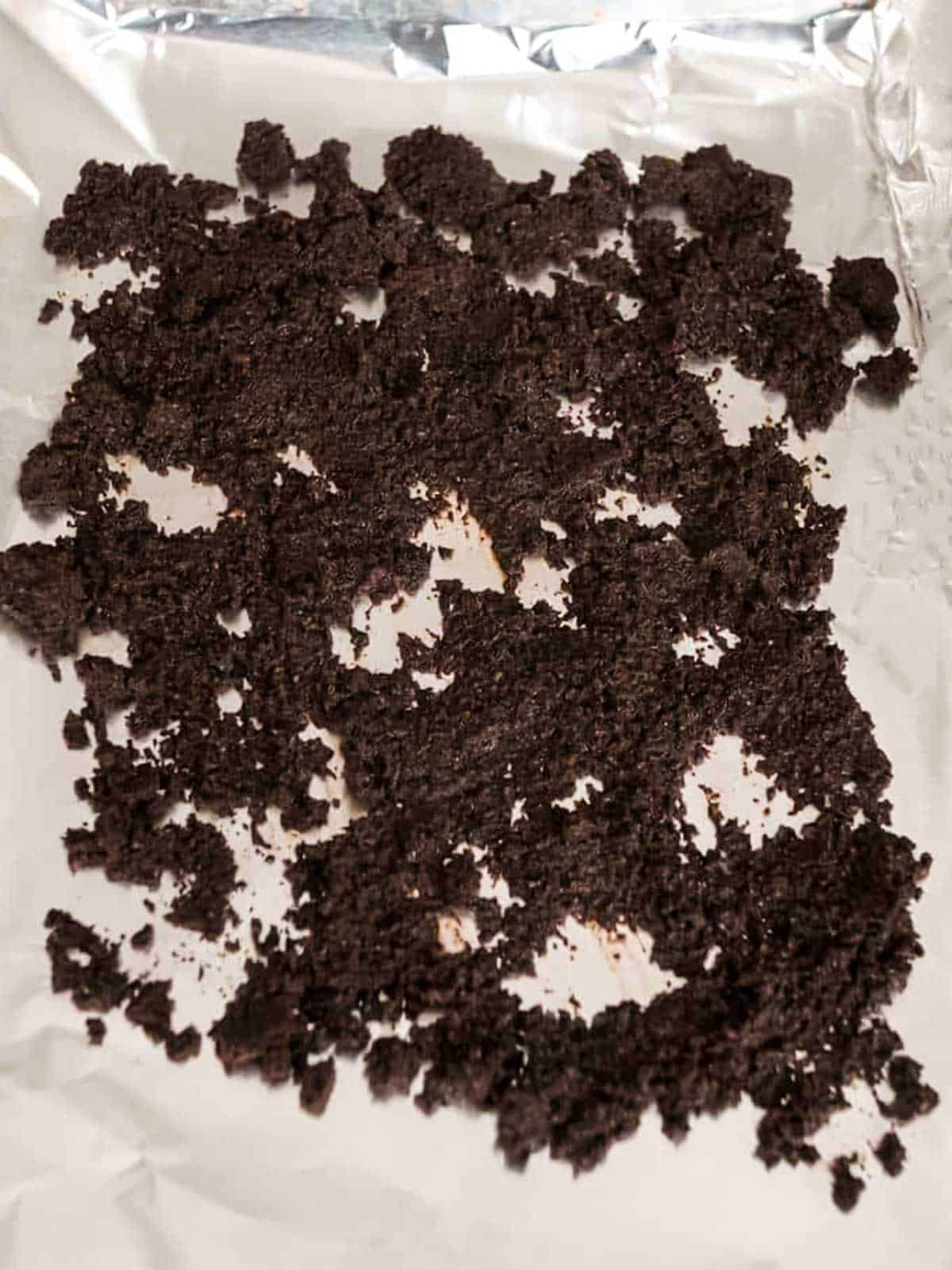 Coffee Grounds spread on an aluminum covered baking sheet.