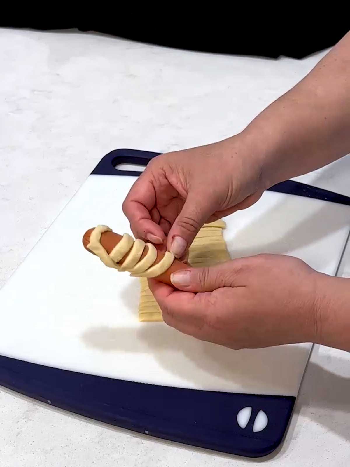 Wrap hot dog with dough strips