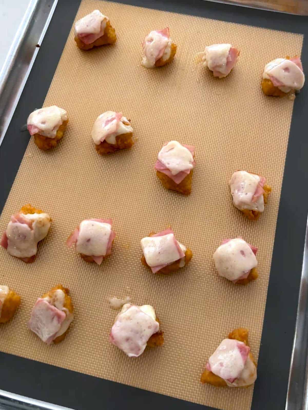 Ham and cheese baked on the chicken nuggets.