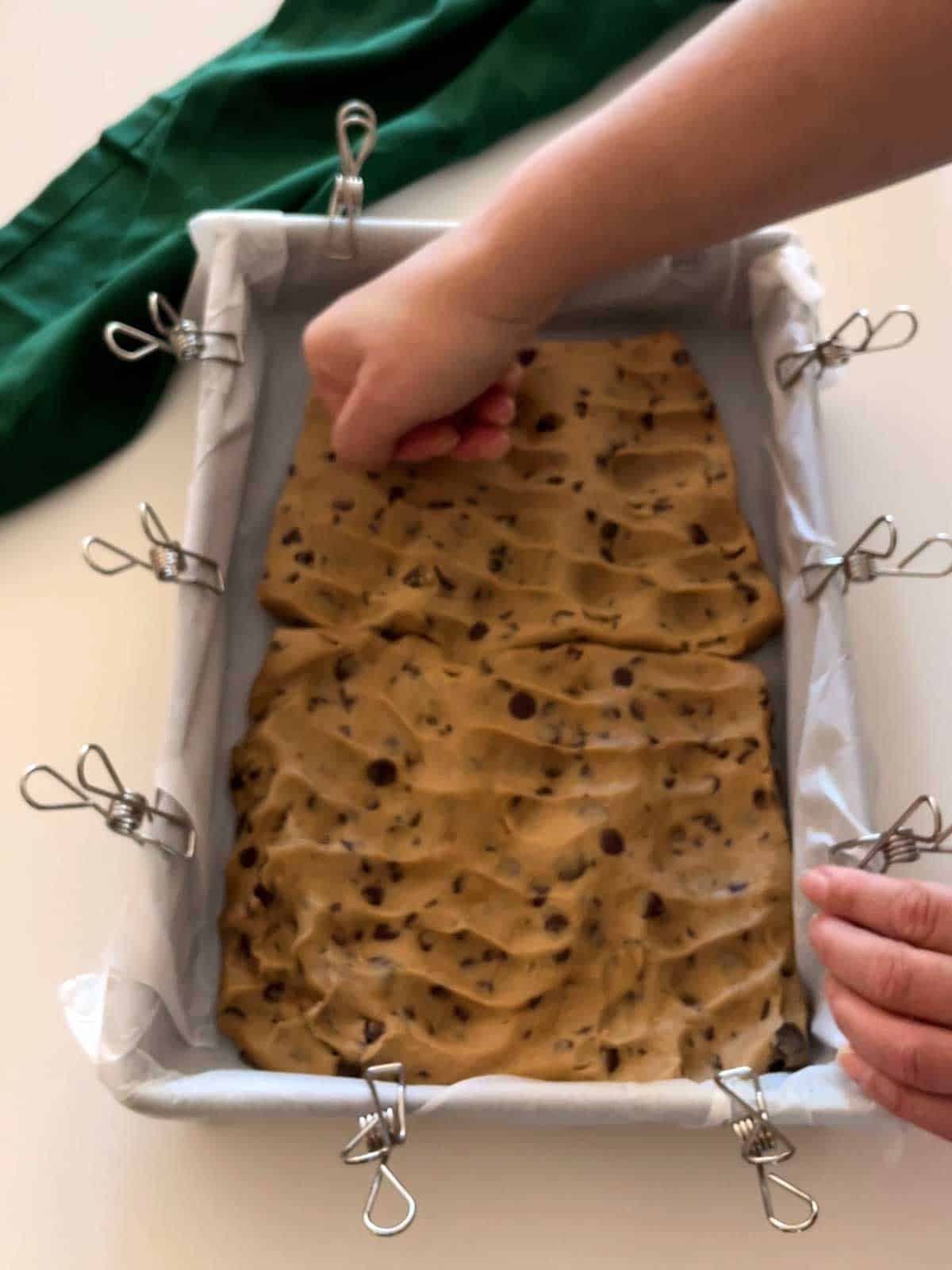 Pressing cookies into prepared pan