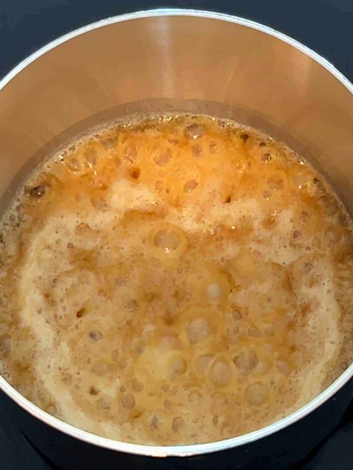 Caramel mixture boiling in the pan.