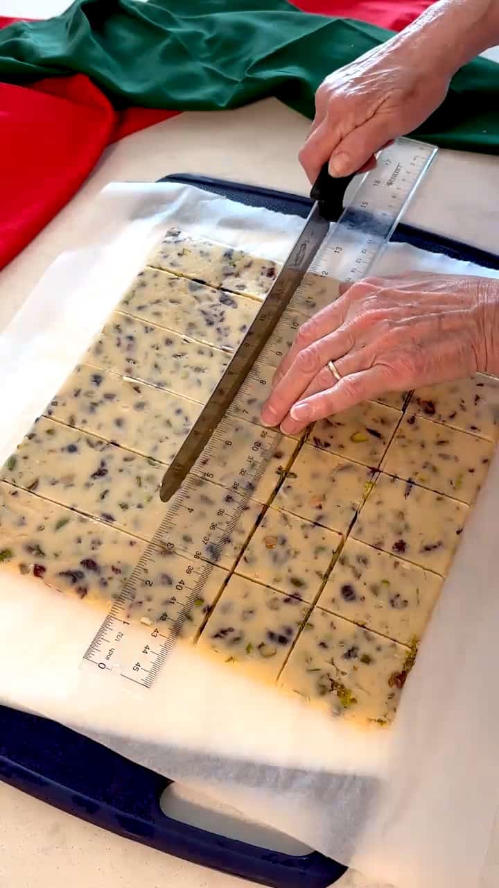 Cutting the dough into squares with a bread knife.