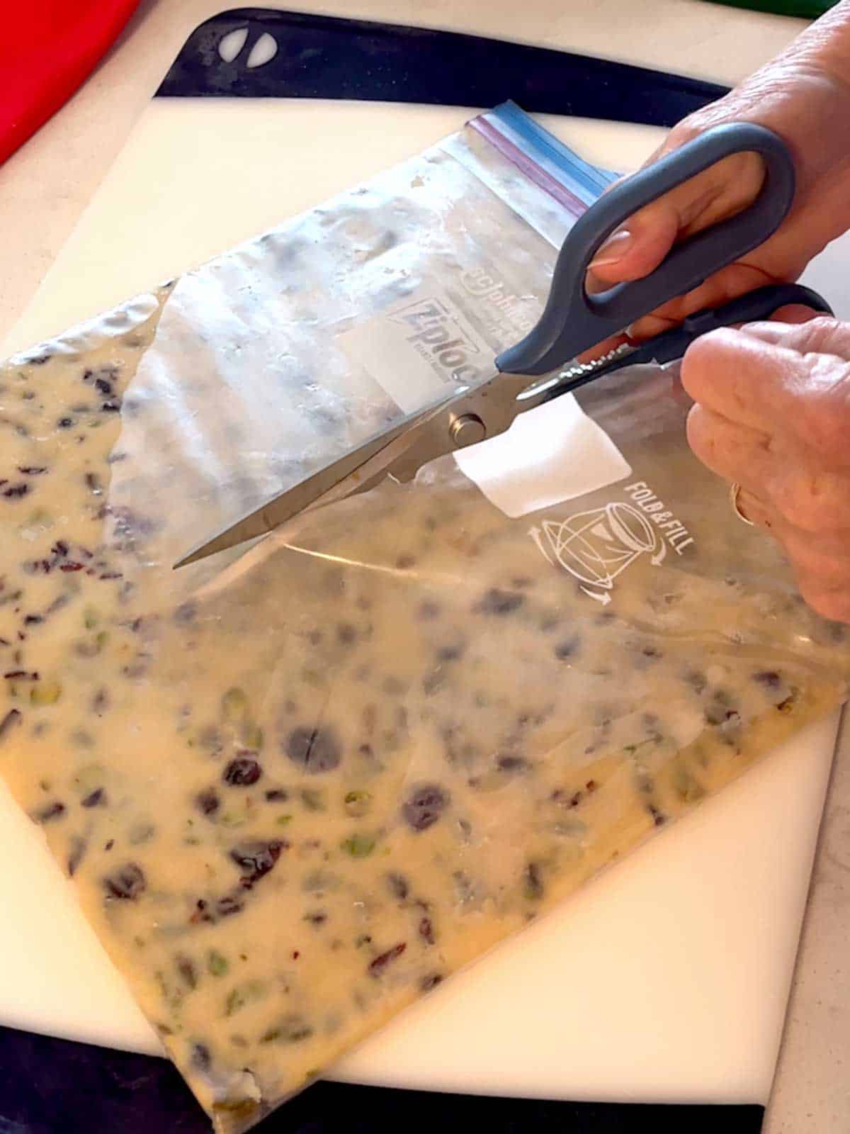 Cutting the Ziploc bag to remove it.