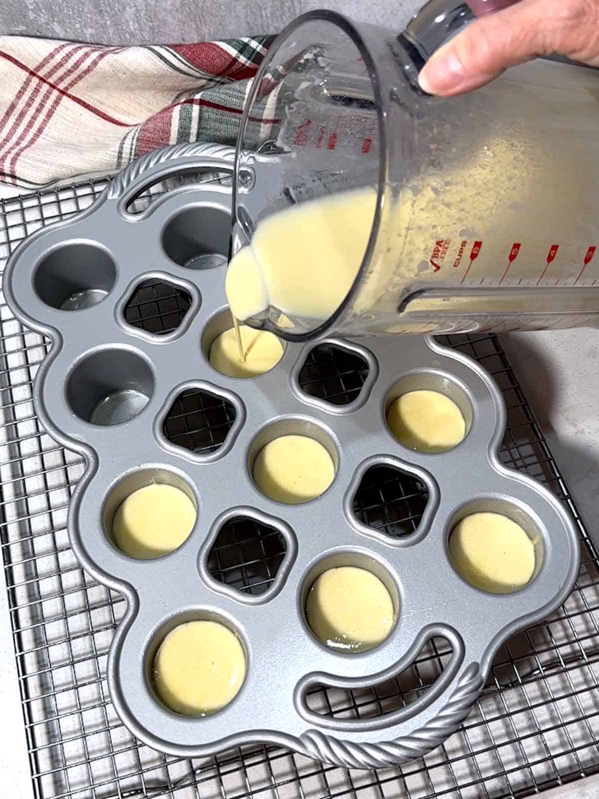 Filling the mni popover pan cups with the batter.