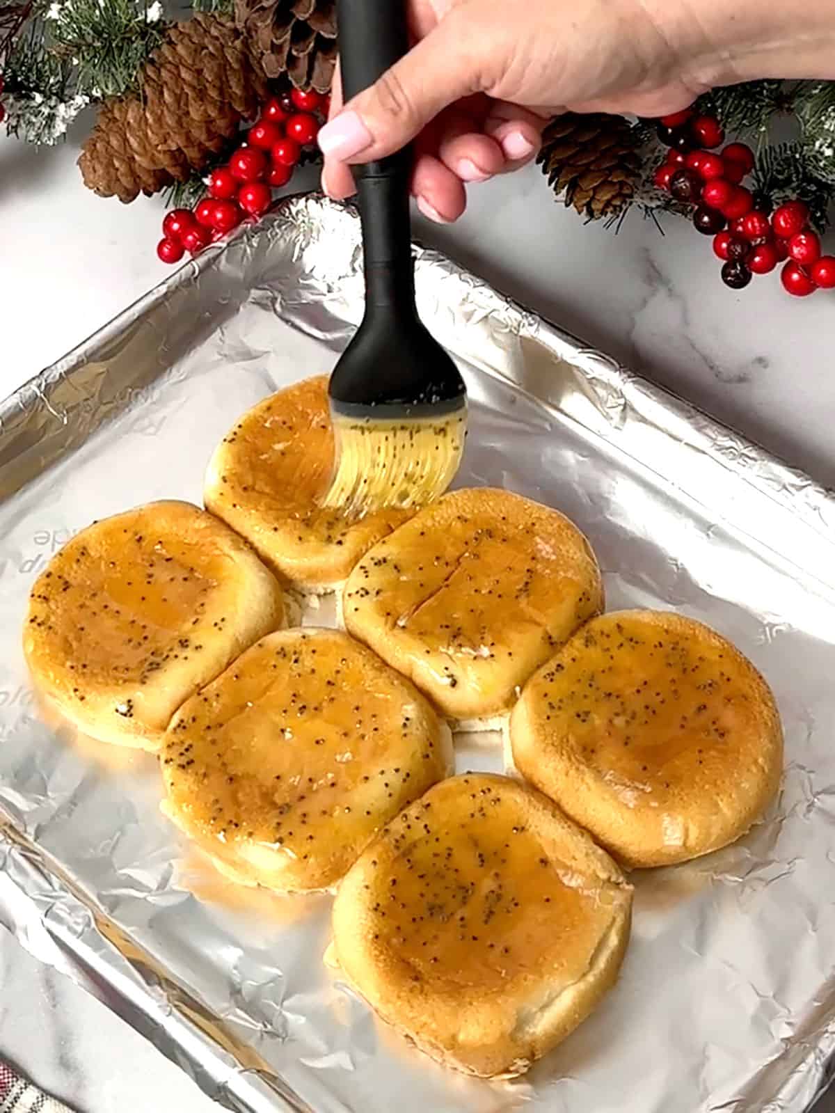 brushing honey butter on bottom buns