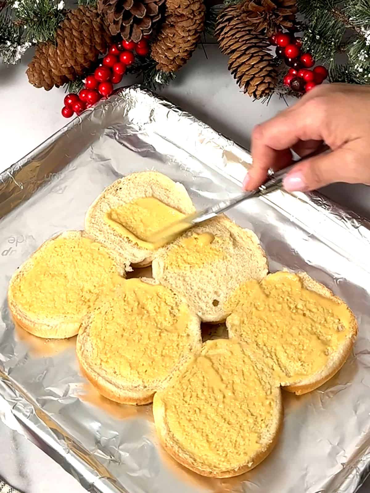 spreading honey mustard on bottom buns