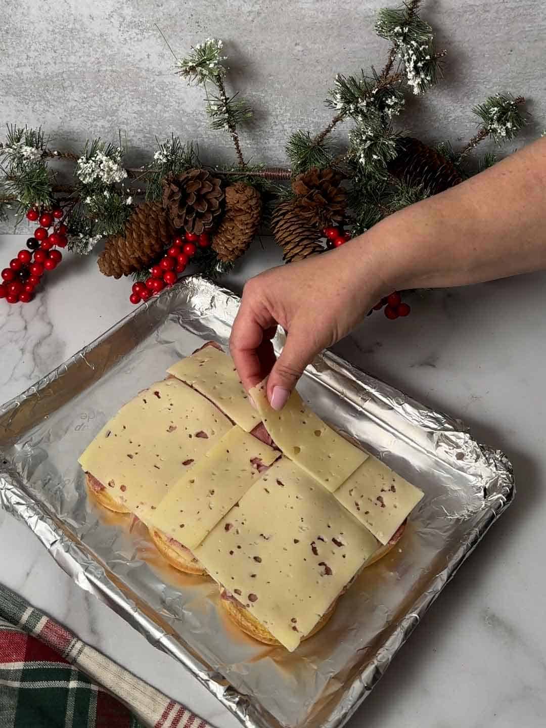 placing top layer of Swiss cheese