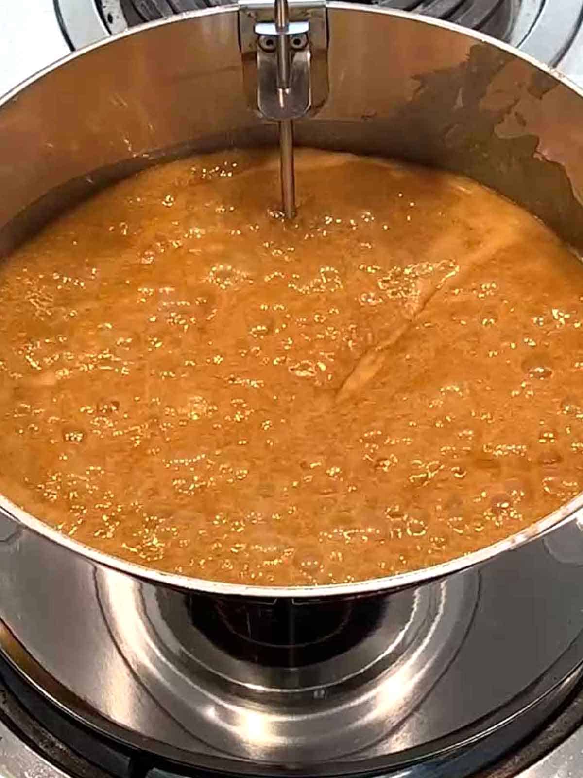 Praline mixture boiling in a saucepan.