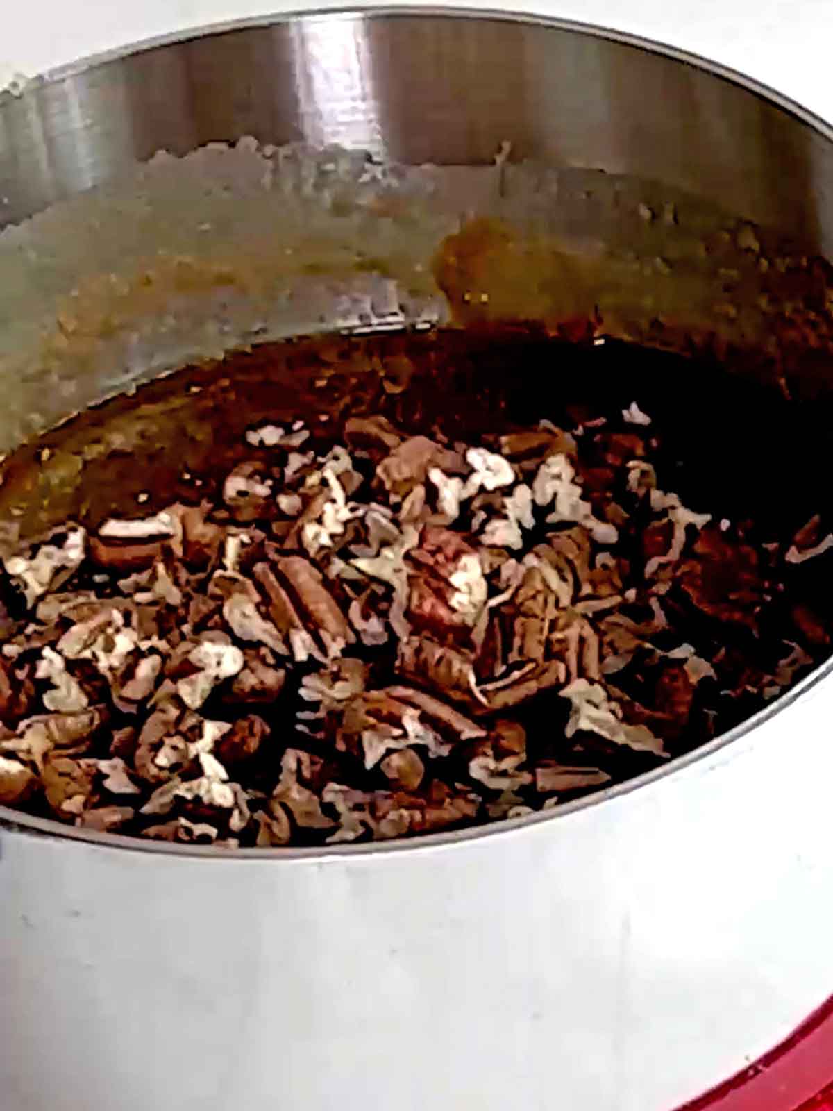 Pecans are added to the praline mixture.