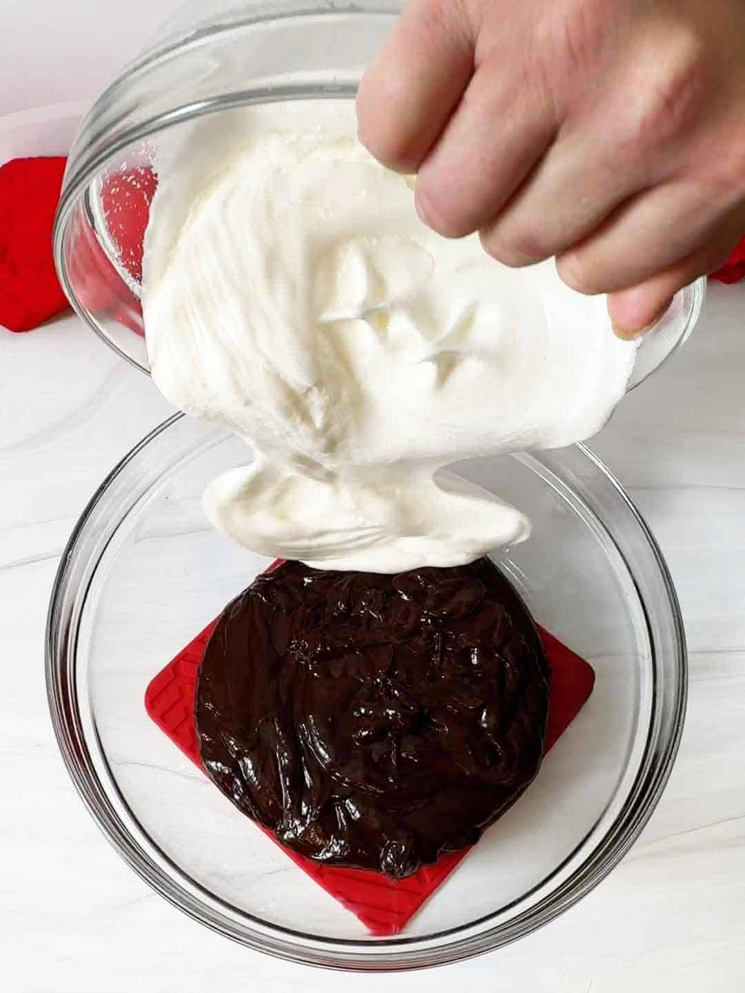 adding whipped egg whites to chocolate