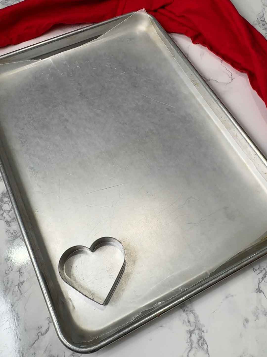 cutter on pan for light pink hearts