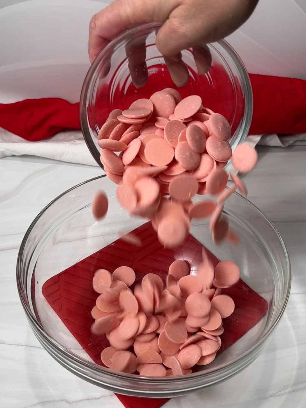 light pink candy disks in bowl