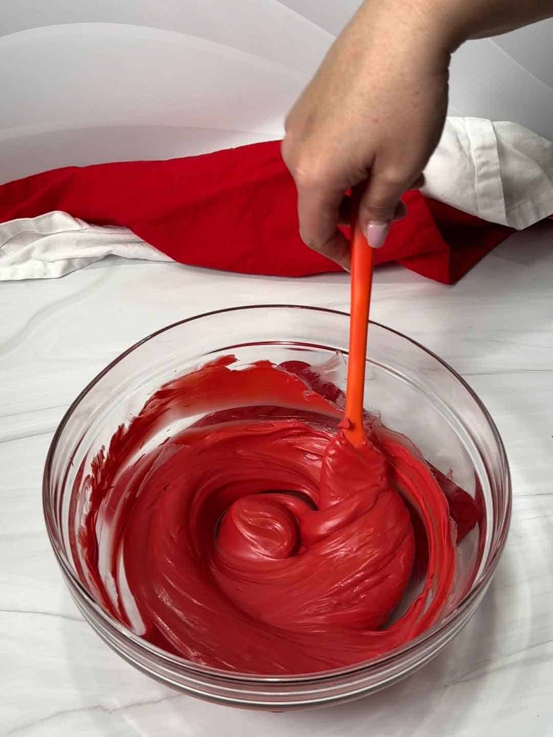 Stirring red candy melts