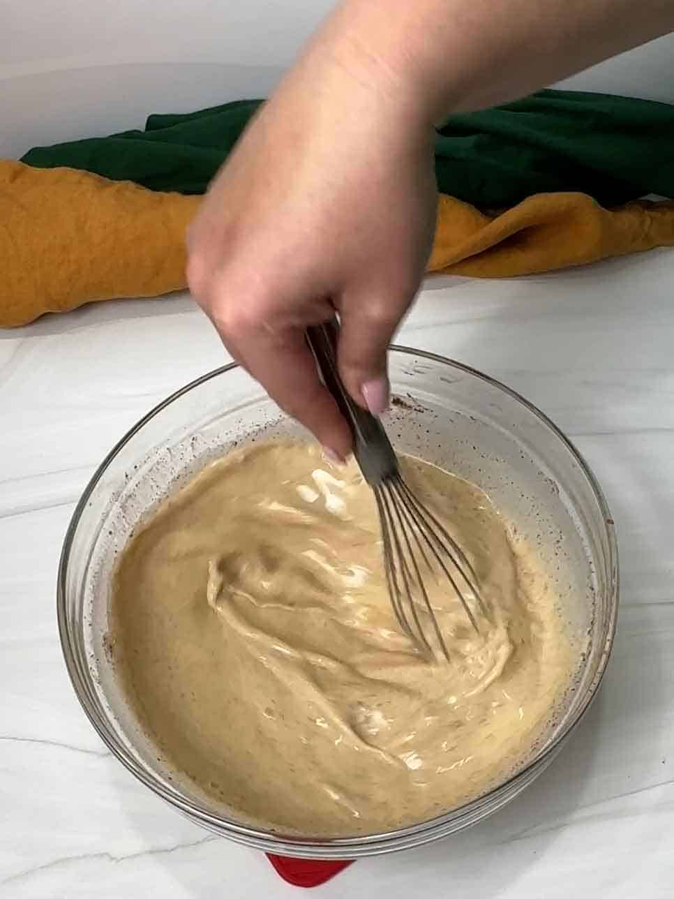 whisking the custard for the Krispy Kreme bread pudding