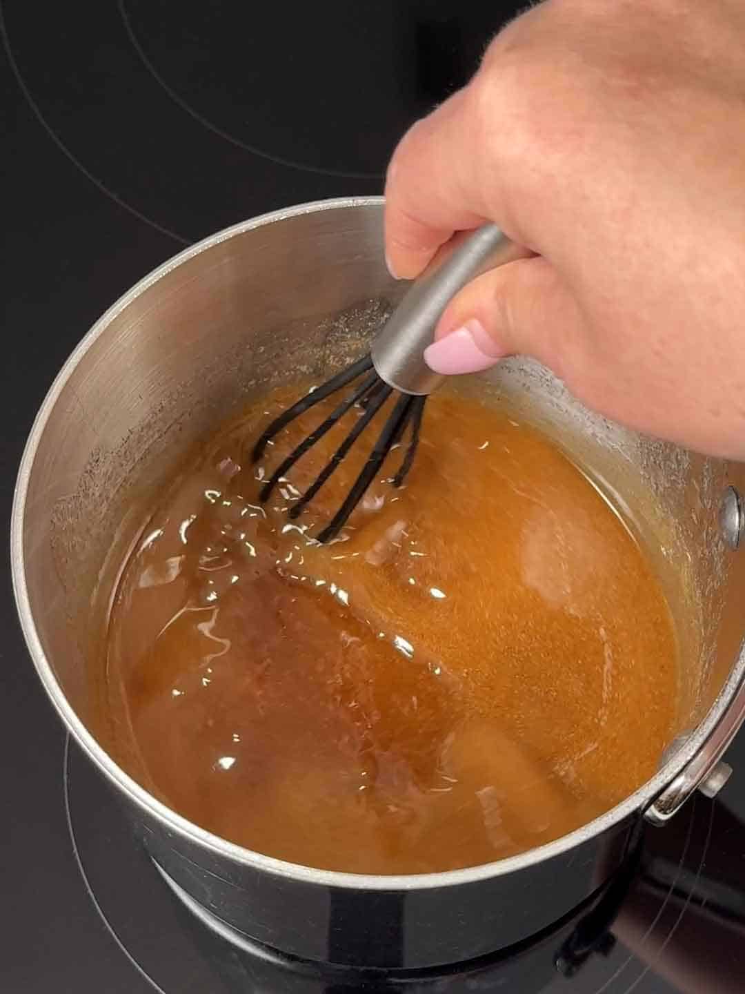 whisking cinnamon and brown sugar with melted butter