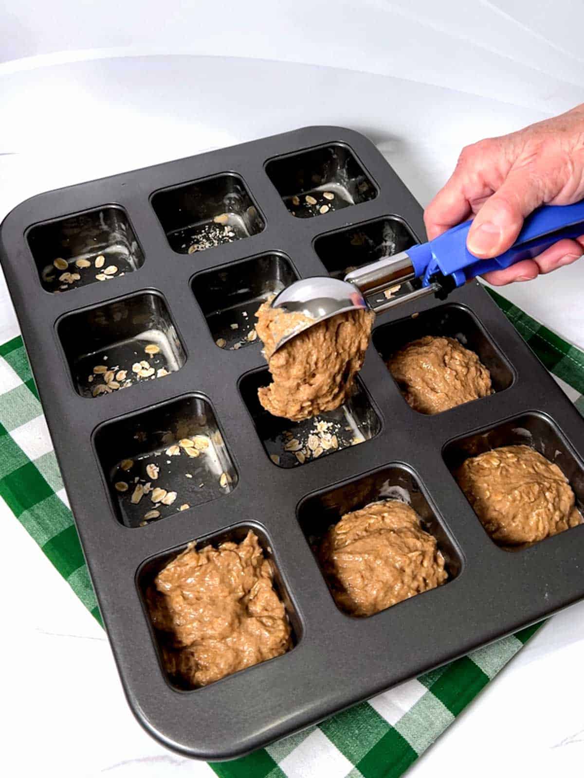 Adding batter to the pan.