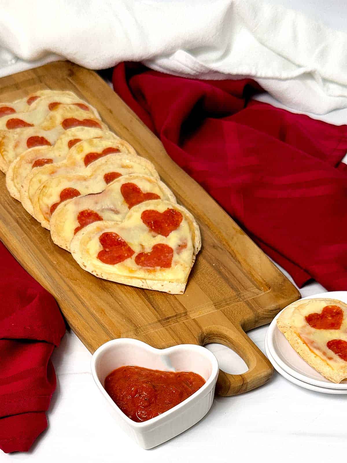 Mini heart-shaped tortilla pizzas.