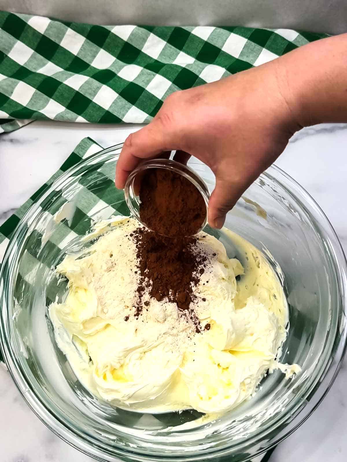 Adding flour, sugar, and cocoa