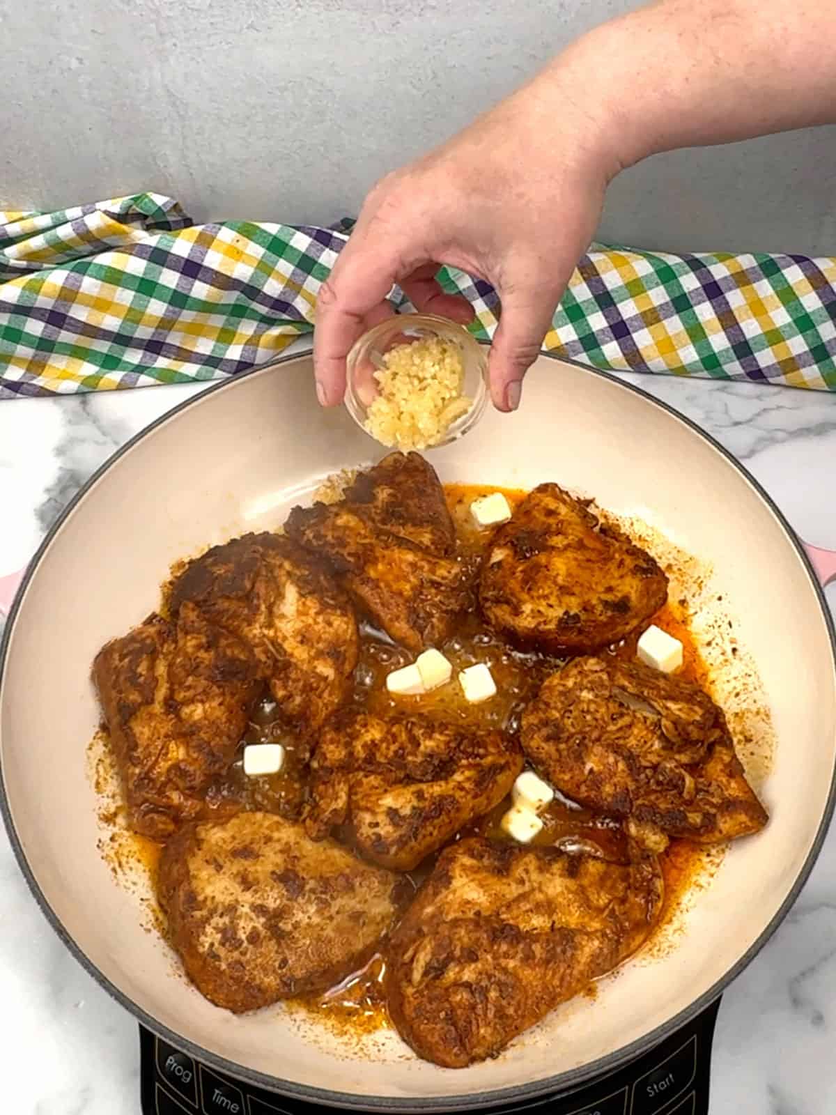 flipping breasts and adding butter and garlic 