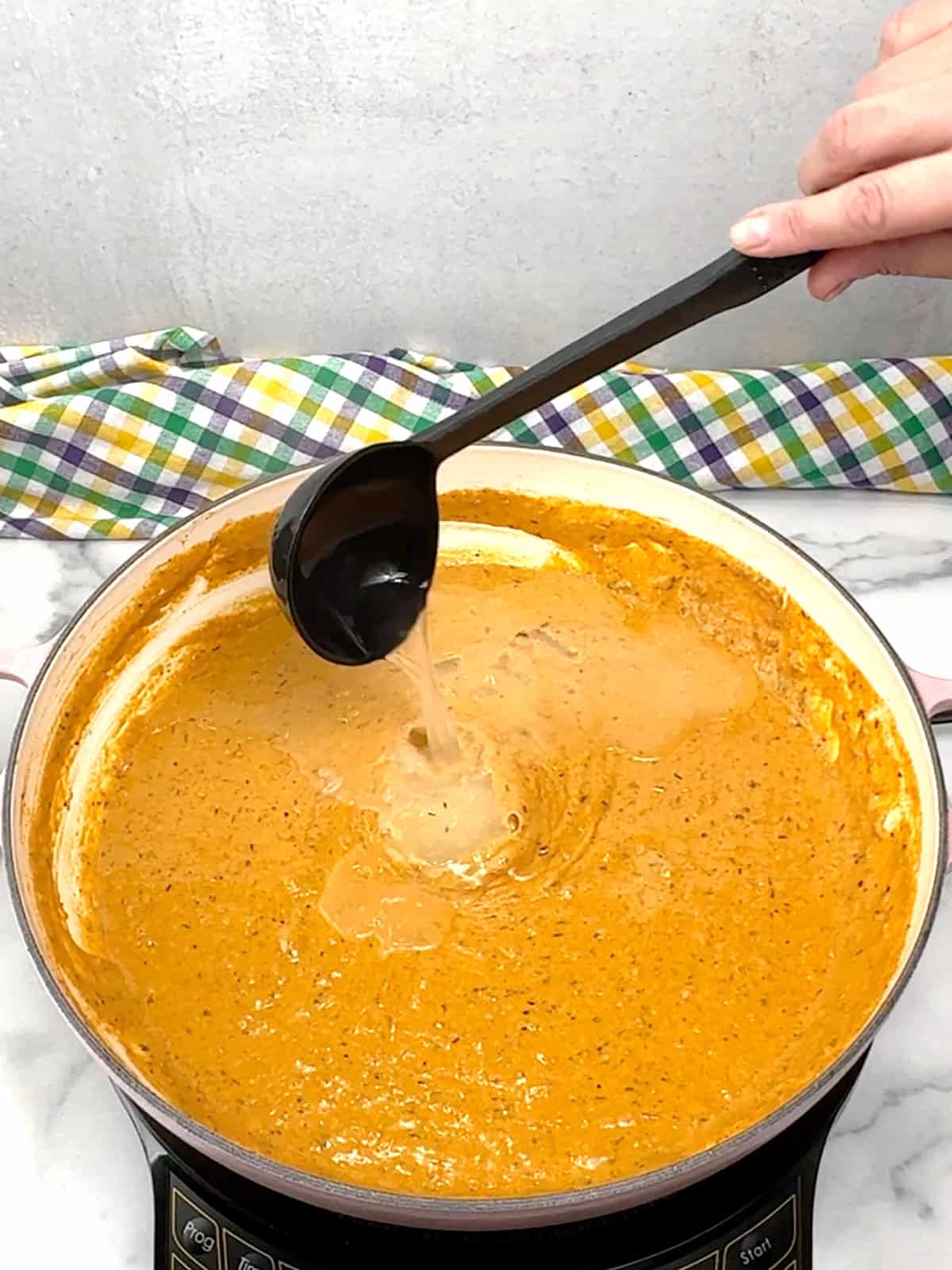 adding reserved pasta water to sauce