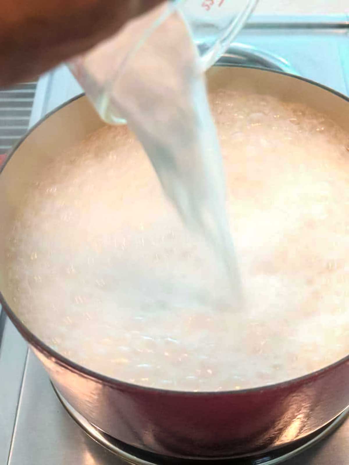 Adding baking soda to the dutch oven.