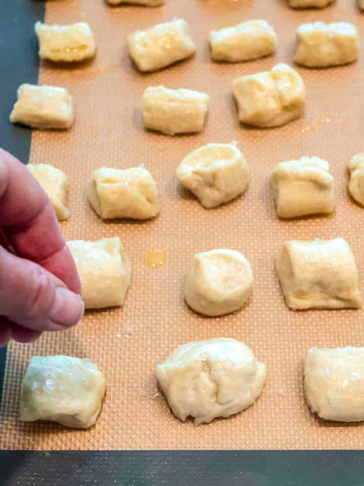 Sprinkling salt on the pretzel bites prior to baking them.