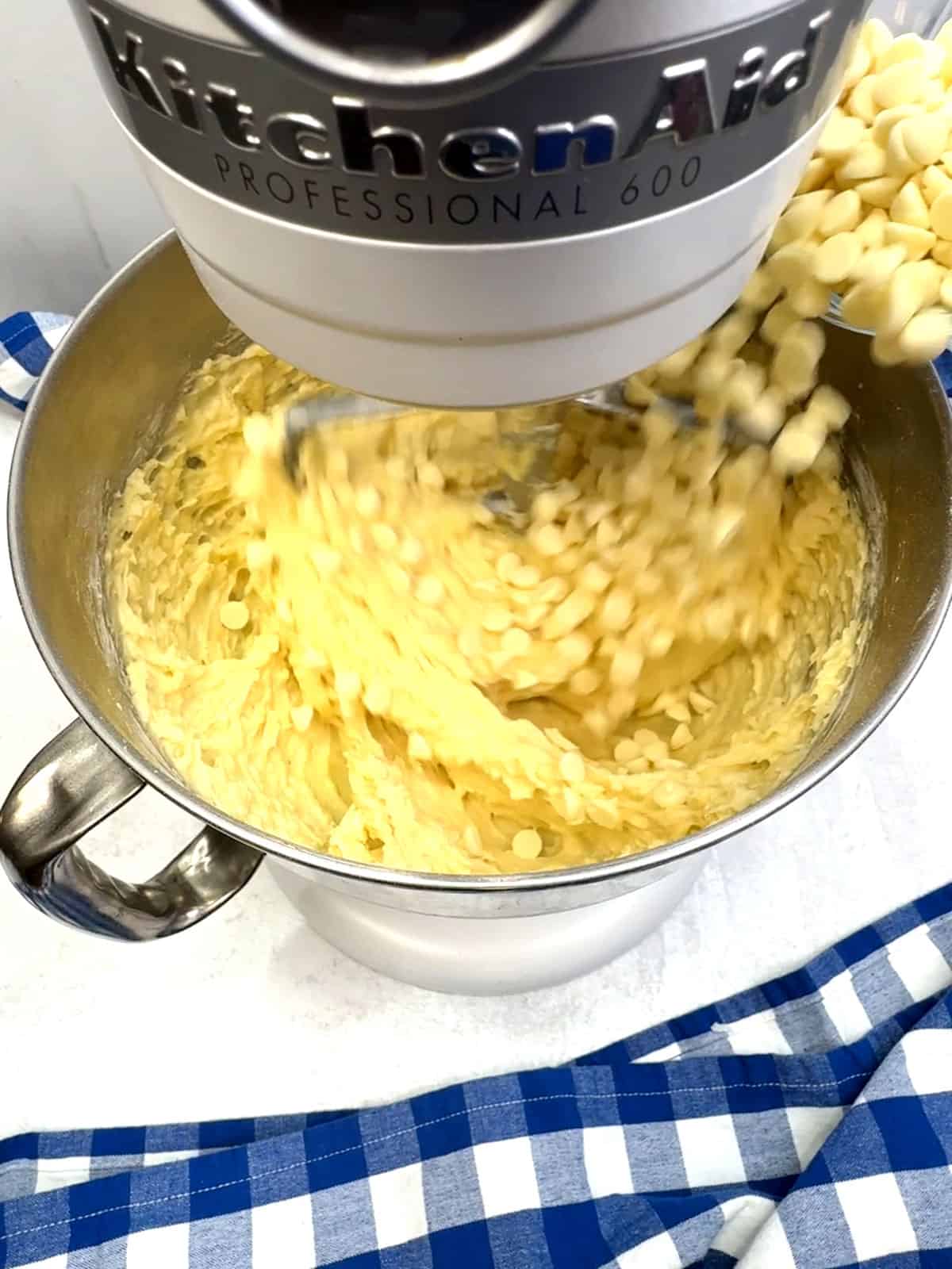 adding white chocolate chips to cake batter