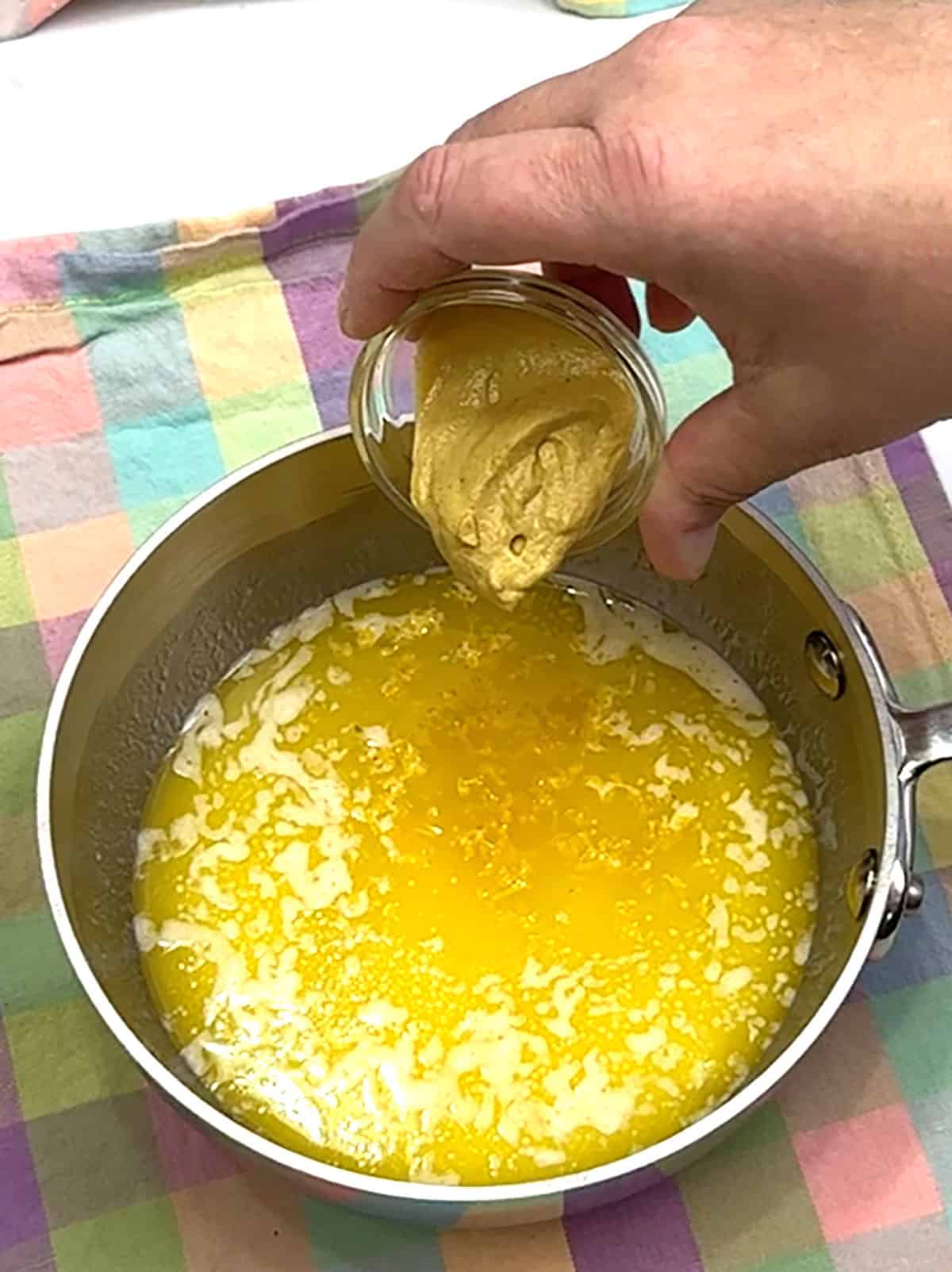 adding dijon mustard to garlic butter