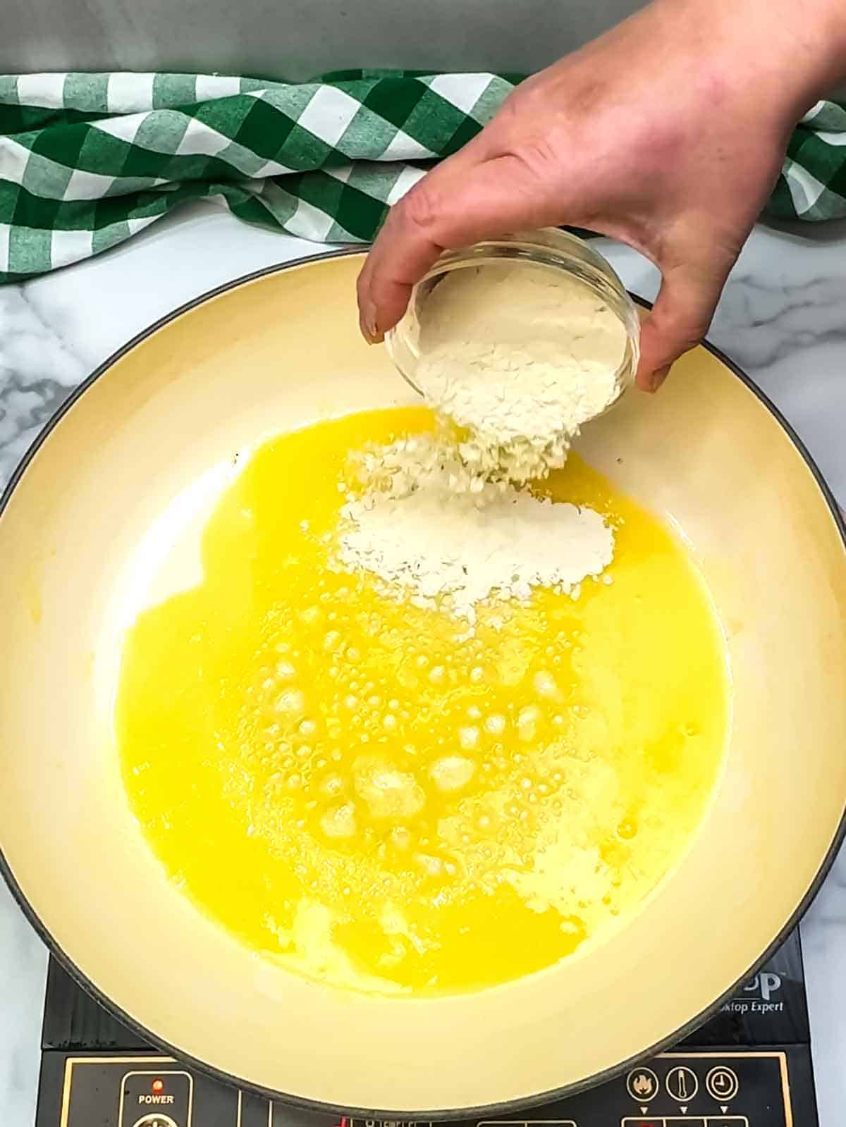 Adding flour to melted butter.