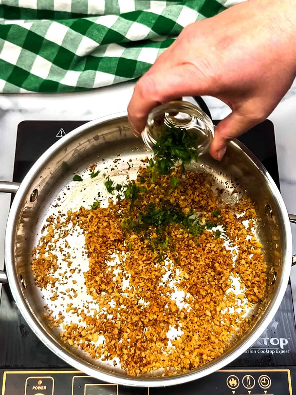 adding freshly minced parsley