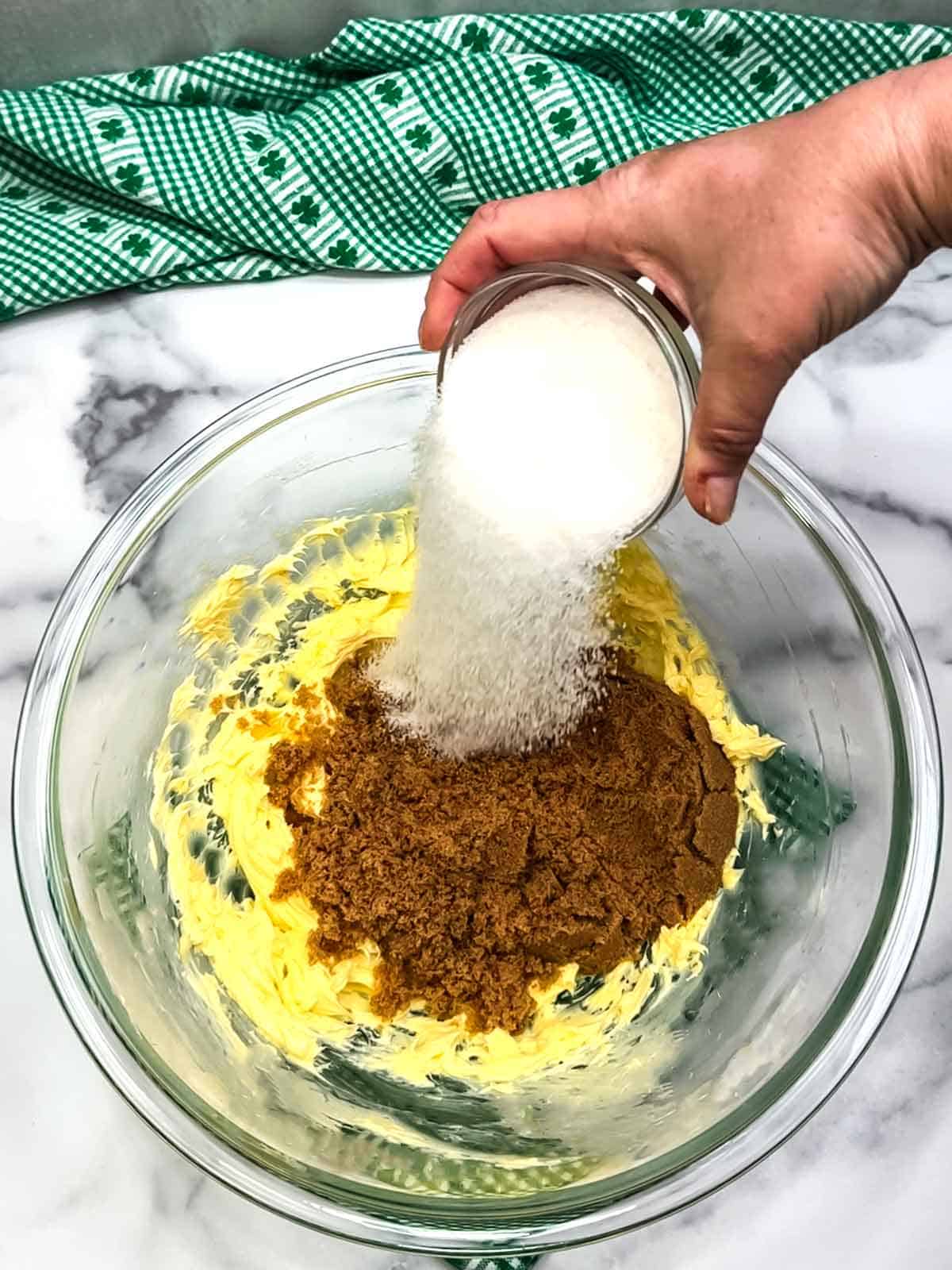 adding sugars to beaten butter