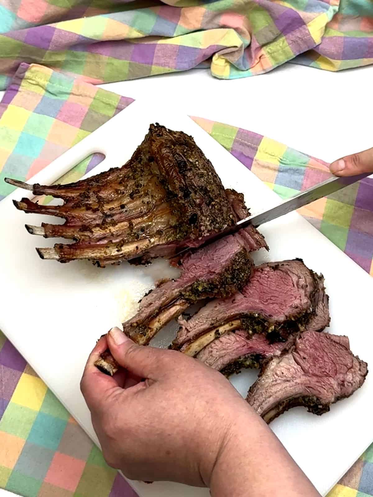 cutting roasted rack of lamb