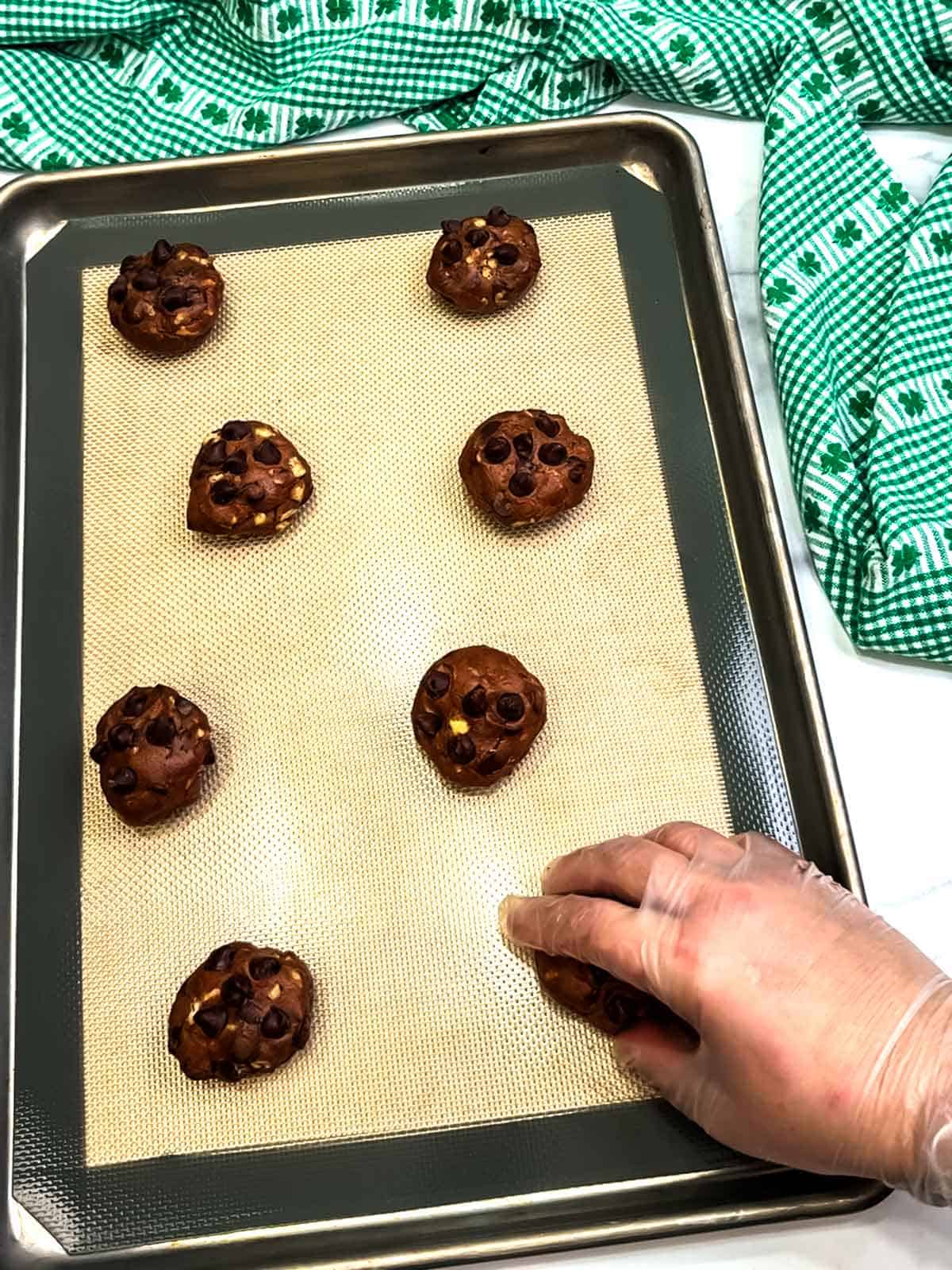 placing dough on prepared baking sheet