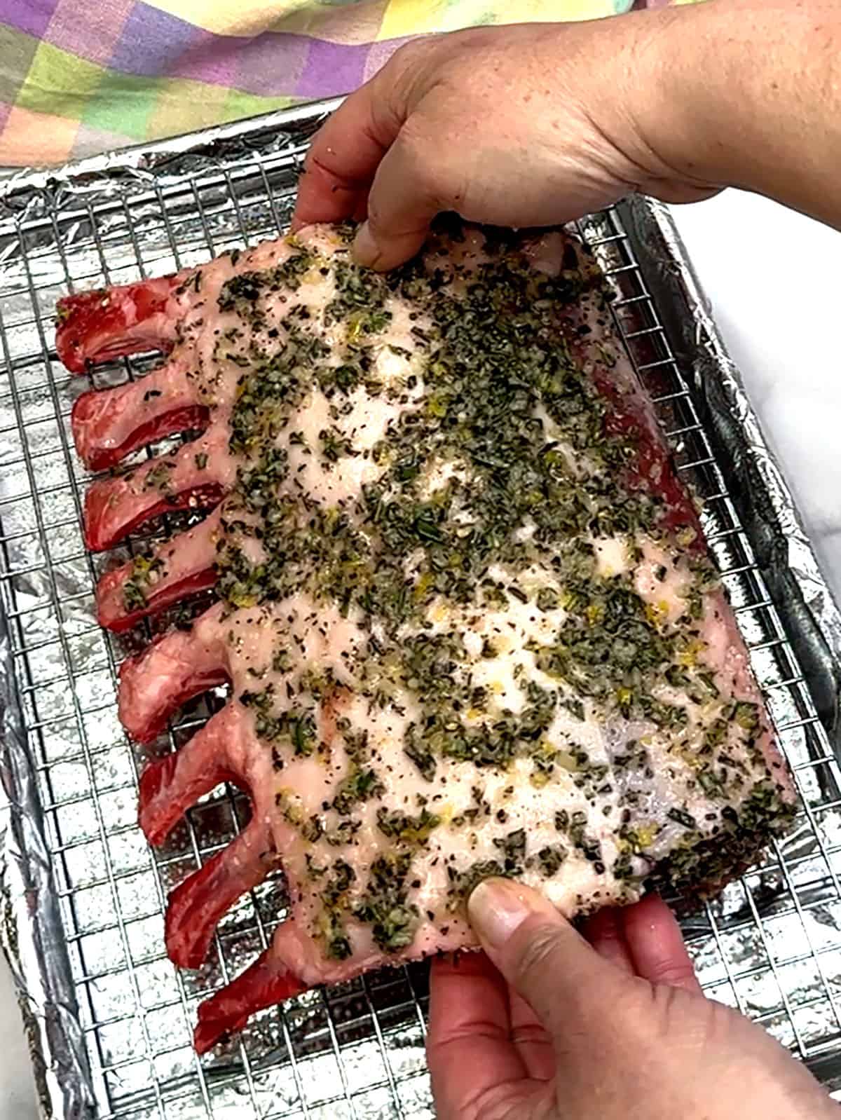 placing lamb rack on prepared pan