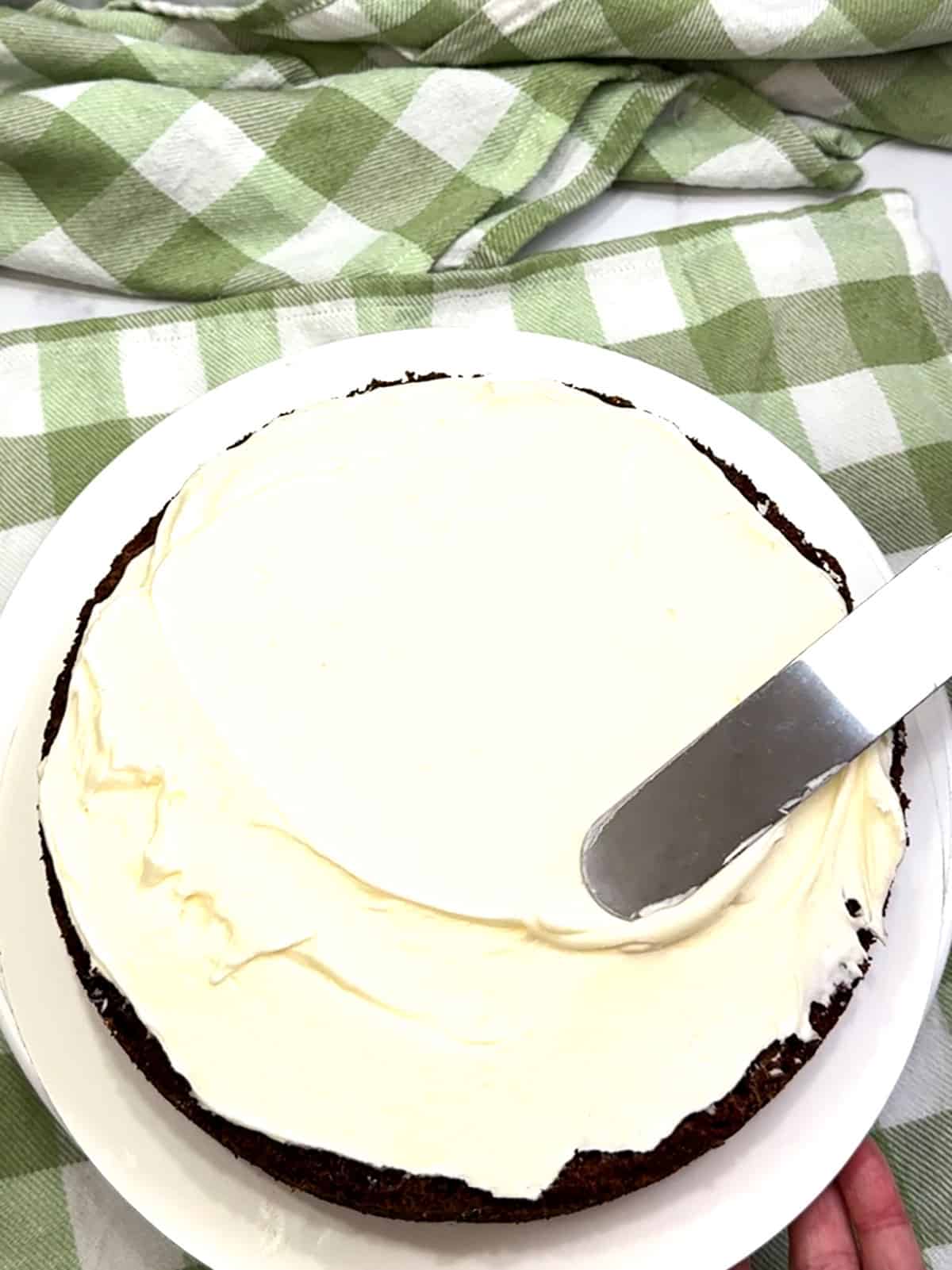 smoothing fist layer of frosting