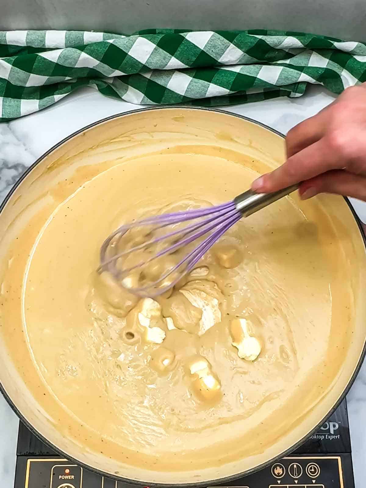 whisking cream cheese pieces