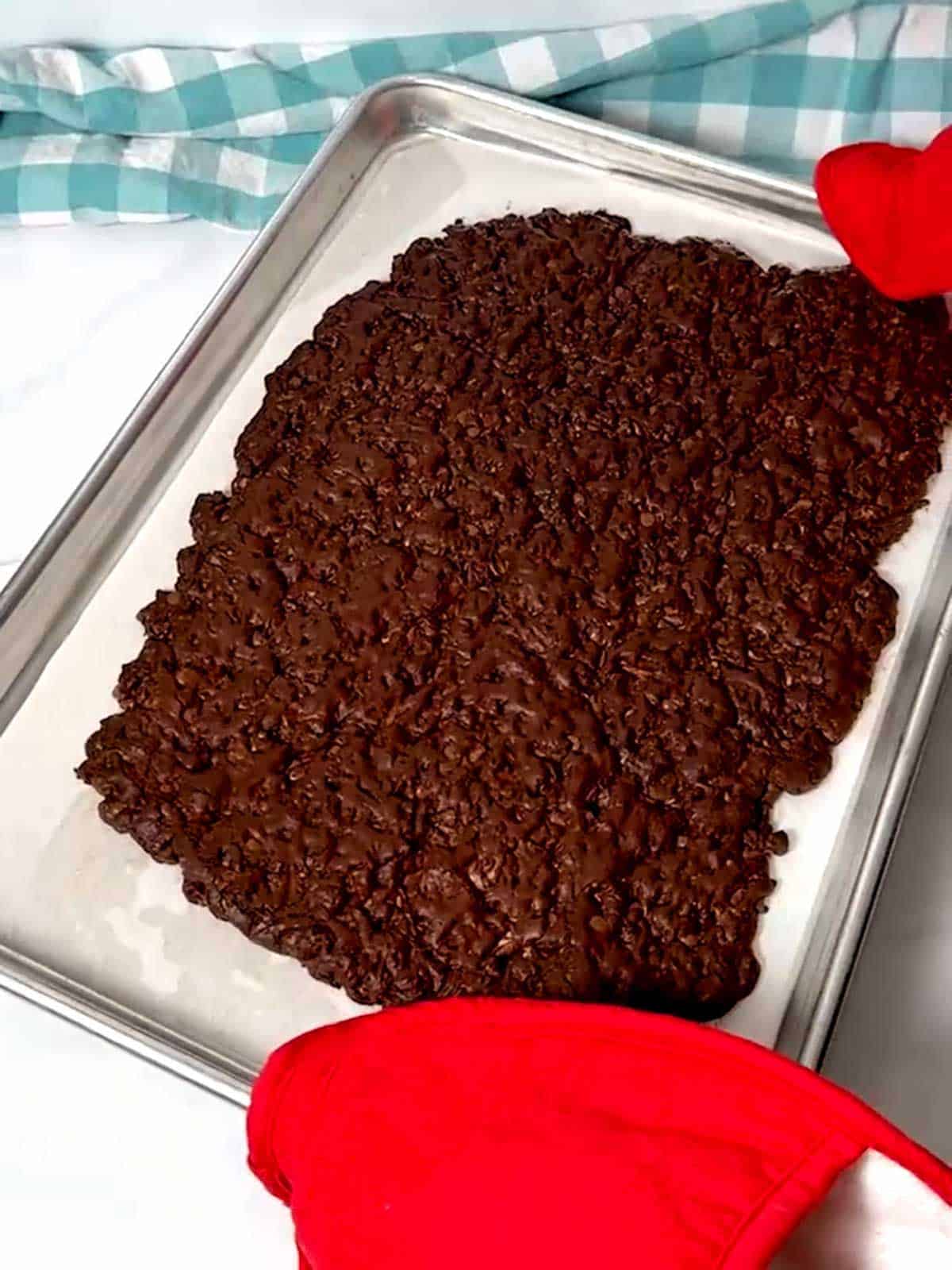 Removing the Brownie Brittle from the oven.